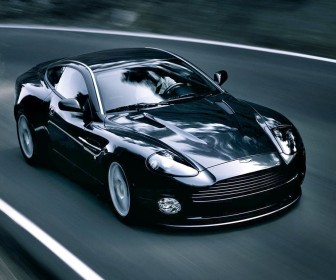 Vanquish V12 Black Driving High Angle Wallpaper